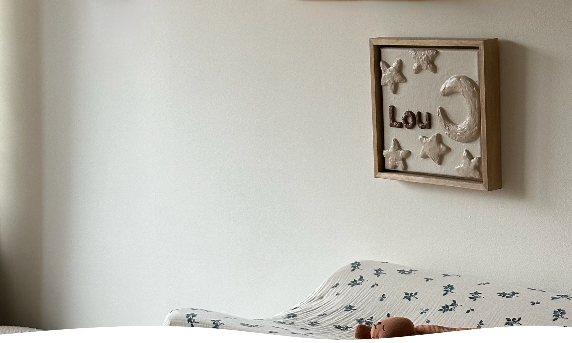 Geboortekaartje op canvas vertaald naar reliëfkunstwerk voor Lou met sterren en de maan aan muur in kinderkamer.